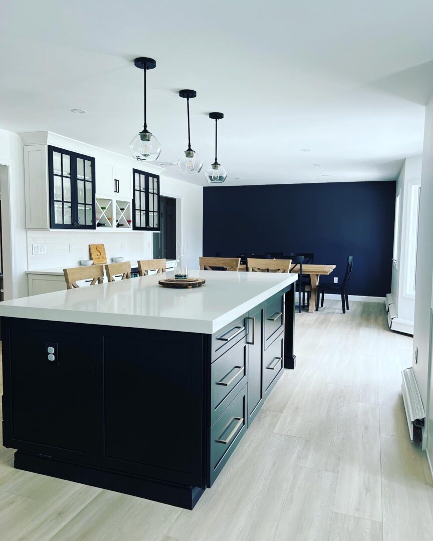 Modern kitchen with a large island and pendant lighting.