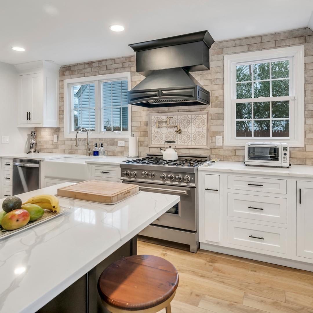 Modern kitchen with white cabinets and large island.