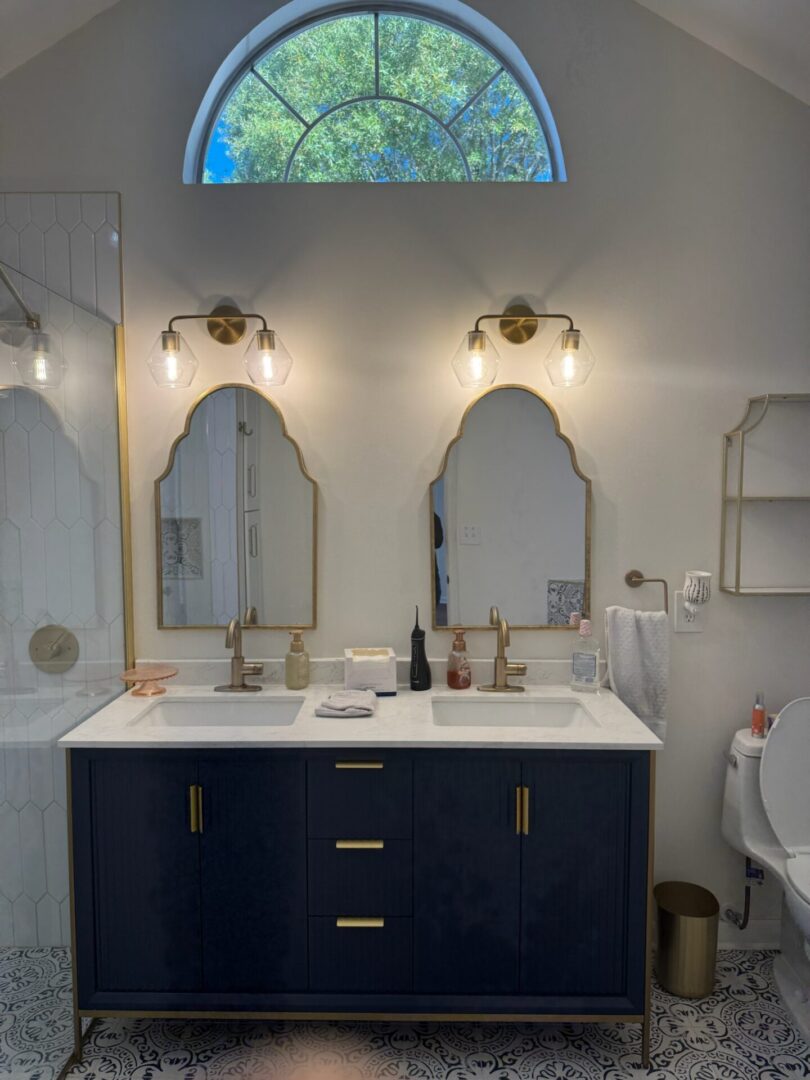 Elegant bathroom vanity with three mirrors and modern lighting.