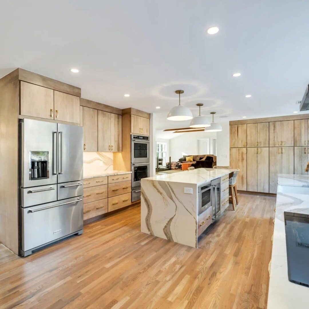 Modern kitchen with wooden cabinets and marble island.